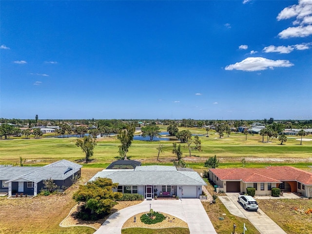 bird's eye view with view of golf course and a water view