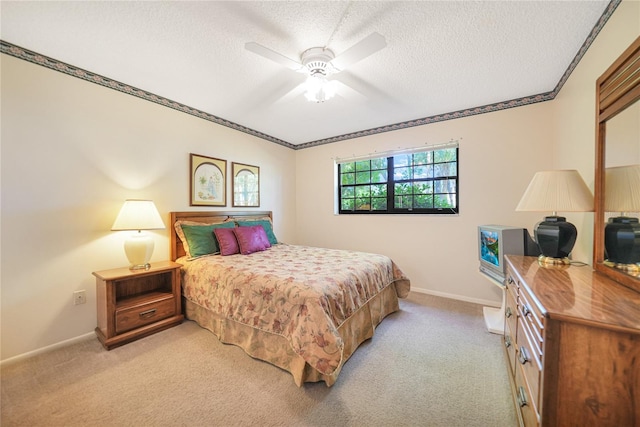 bedroom with a textured ceiling, light colored carpet, and baseboards
