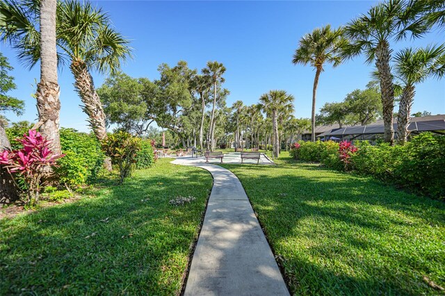 view of property's community with a lawn