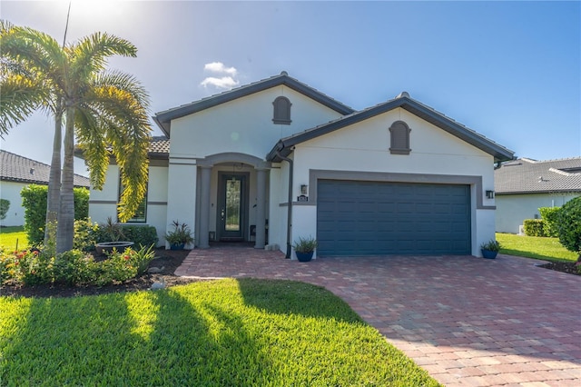 6763 Winding Cypress Dr, Naples, FL 34114 - view of front of house featuring decorative driveway, a garage, a front yard, and stucco siding