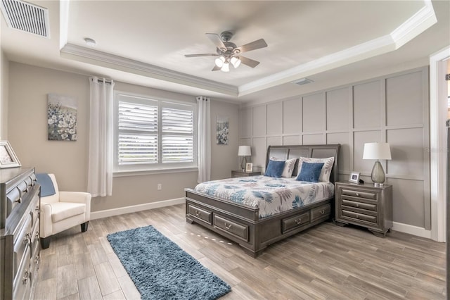 6763 Winding Cypress Dr, Naples, FL 34114 - bedroom with visible vents, crown molding, and a tray ceiling