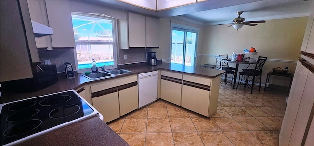 570 Mimosa Ave NW, Port Charlotte, FL 33952 - kitchen featuring a sink, white appliances, under cabinet range hood, white cabinets, and a peninsula