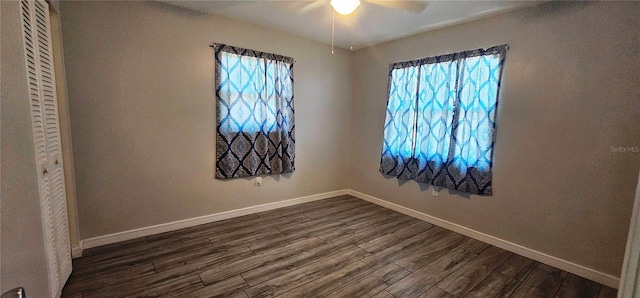 570 Mimosa Ave NW, Port Charlotte, FL 33952 - spare room with a ceiling fan, dark wood-style flooring, and baseboards
