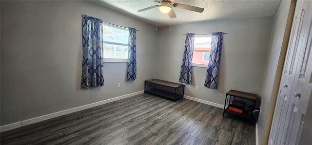 570 Mimosa Ave NW, Port Charlotte, FL 33952 - spare room with healthy amount of natural light, a textured ceiling, wood finished floors, a ceiling fan, and baseboards