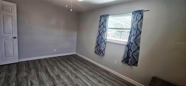 570 Mimosa Ave NW, Port Charlotte, FL 33952 - spare room featuring dark wood finished floors and baseboards