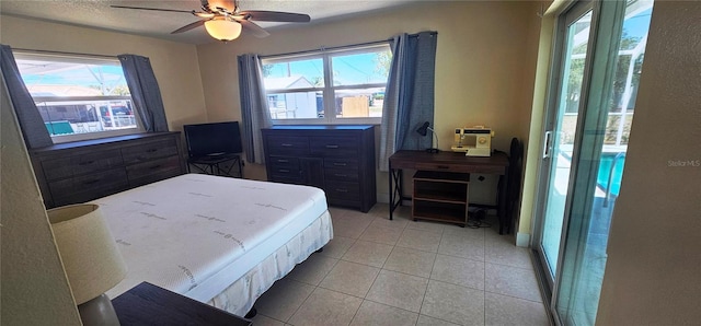 570 Mimosa Ave NW, Port Charlotte, FL 33952 - bedroom with multiple windows, light tile patterned floors, and a ceiling fan