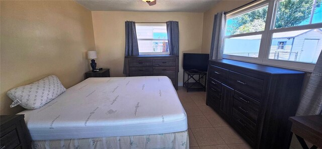 570 Mimosa Ave NW, Port Charlotte, FL 33952 - bedroom featuring multiple windows and light tile patterned floors