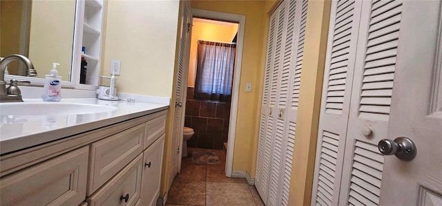 570 Mimosa Ave NW, Port Charlotte, FL 33952 - full bath featuring a closet, vanity, toilet, and tile patterned floors