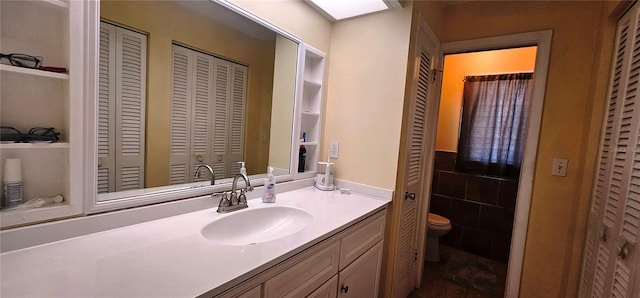 570 Mimosa Ave NW, Port Charlotte, FL 33952 - bathroom featuring a closet, toilet, and vanity