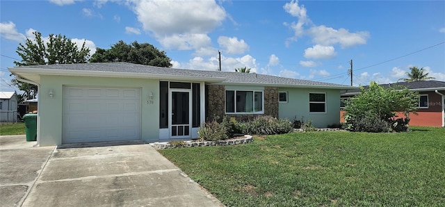 570 Mimosa Ave NW, Port Charlotte, FL 33952 - ranch-style home featuring a garage, a front lawn, stucco siding, concrete driveway, and stone siding
