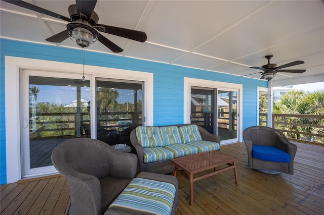 wooden terrace with a ceiling fan and outdoor lounge area