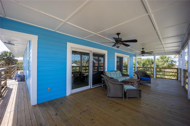 wooden deck with a ceiling fan and an outdoor living space
