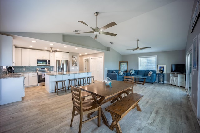 dining area with light wood-type flooring, a ceiling fan, and visible vents