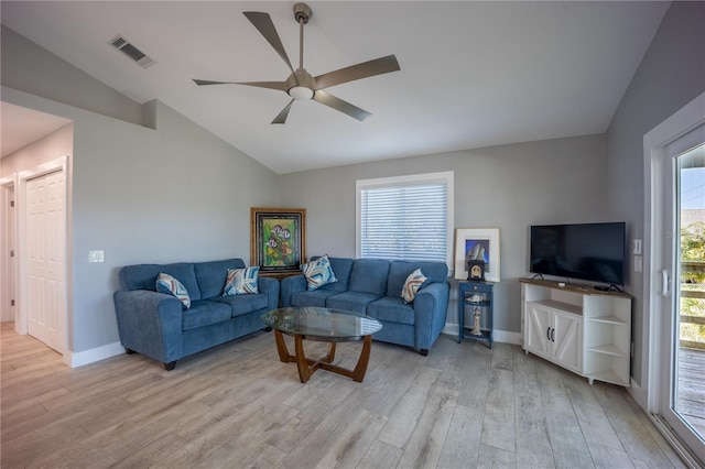 living room featuring a ceiling fan, light wood finished floors, visible vents, and vaulted ceiling