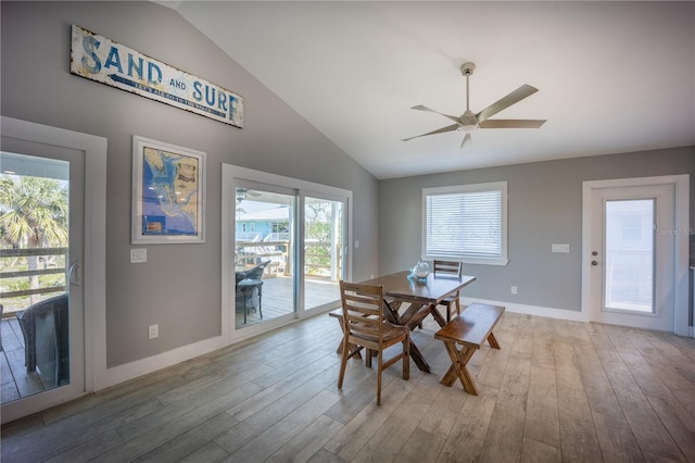 dining area with vaulted ceiling, wood finished floors, baseboards, and ceiling fan