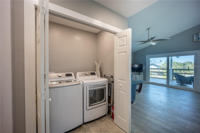 laundry room featuring laundry area, light wood-type flooring, a ceiling fan, and washing machine and clothes dryer