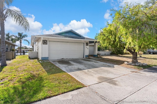 view of front facade with driveway, a front lawn, and a garage