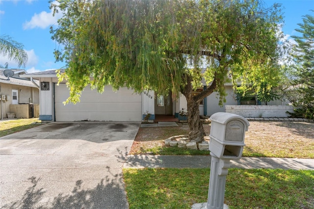 obstructed view of property featuring an attached garage and driveway