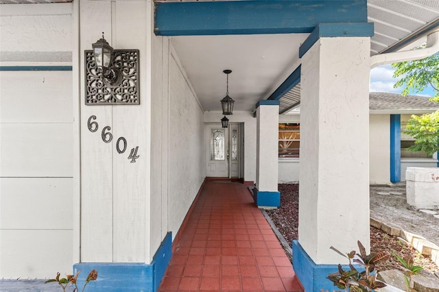 view of exterior entry with a porch