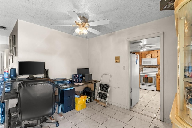 office with tile patterned floors, ceiling fan, a textured ceiling, and visible vents