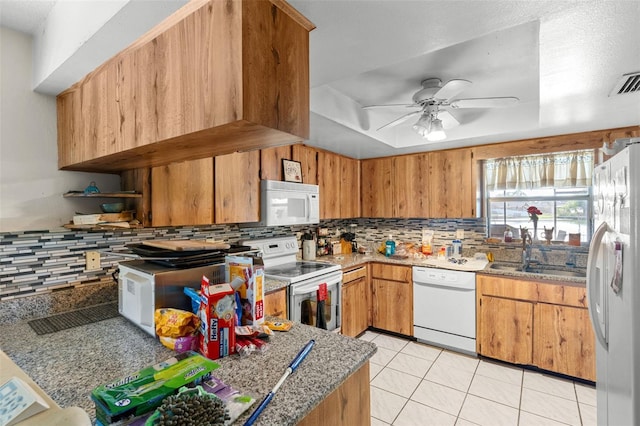 kitchen with white appliances, a ceiling fan, a sink, and tasteful backsplash