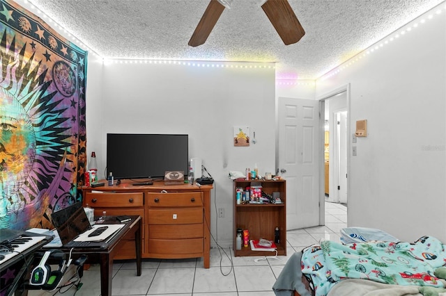 bedroom with a ceiling fan, a textured ceiling, and light tile patterned floors