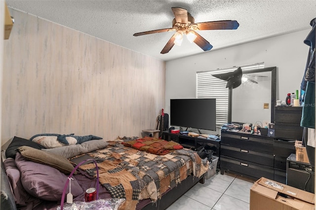 bedroom with light tile patterned flooring, a textured ceiling, and ceiling fan