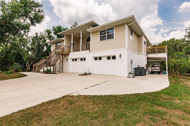 view of front of house featuring a garage, stairs, ceiling fan, and concrete driveway