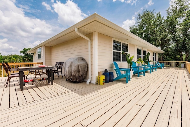 deck with area for grilling and outdoor dining space