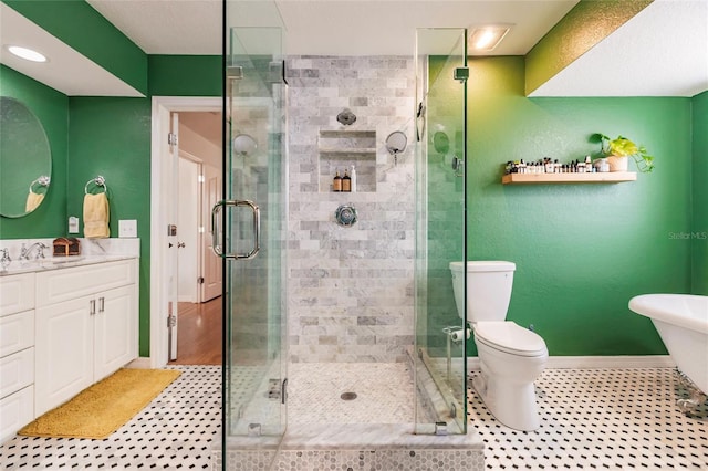 full bathroom featuring a stall shower, vanity, baseboards, tile patterned floors, and toilet