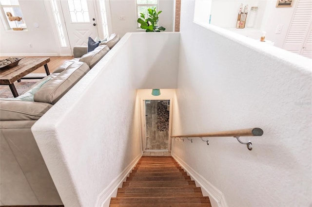 stairs with baseboards and wood finished floors