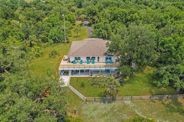 birds eye view of property featuring a view of trees