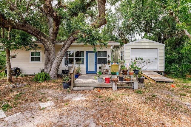 single story home featuring a shed and an outbuilding