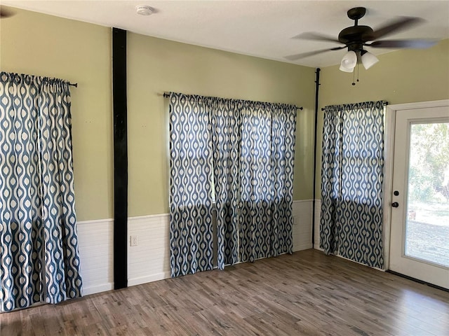empty room featuring a ceiling fan and wood finished floors