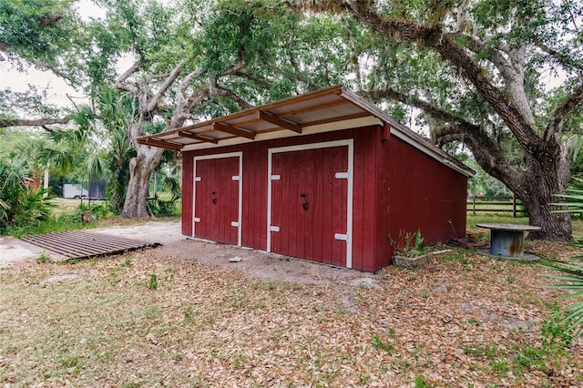 view of shed with fence