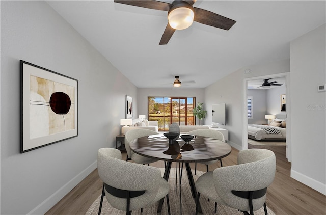 dining area featuring a ceiling fan, baseboards, and wood finished floors