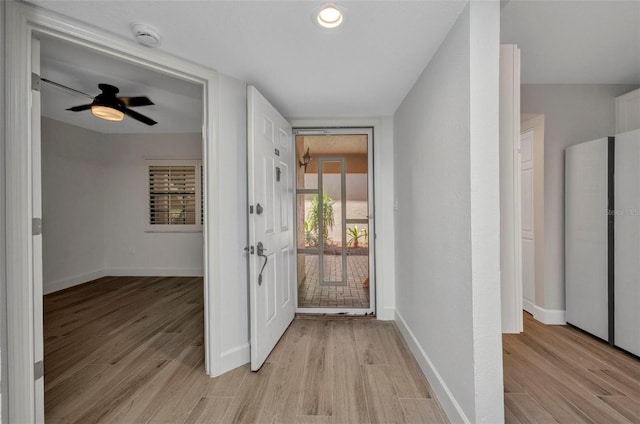 interior space featuring baseboards, ceiling fan, and light wood-type flooring
