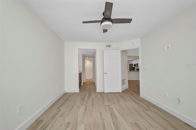 unfurnished bedroom with baseboards, visible vents, ceiling fan, and light wood-style floors
