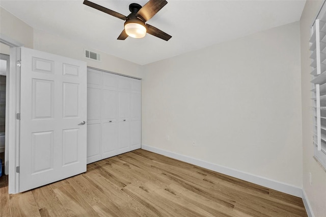 unfurnished bedroom with visible vents, a closet, baseboards, a ceiling fan, and light wood-style flooring