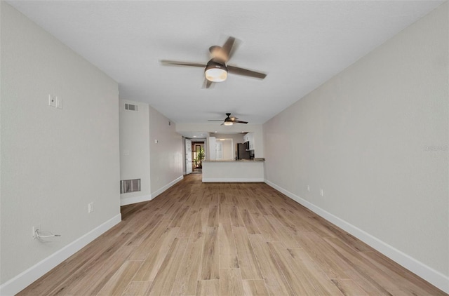 unfurnished living room with a ceiling fan, baseboards, visible vents, and light wood-type flooring