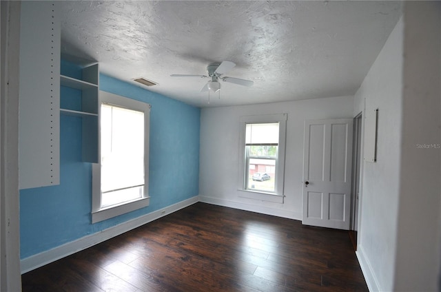 214 W Whidden St, Arcadia, FL 34266 - spare room featuring baseboards, dark wood-type flooring, ceiling fan, and a textured ceiling