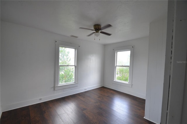 214 W Whidden St, Arcadia, FL 34266 - unfurnished room with healthy amount of natural light, baseboards, ceiling fan, and dark wood-type flooring