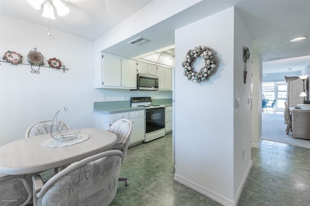 kitchen with baseboards, visible vents, stainless steel microwave, white electric range oven, and tile patterned floors