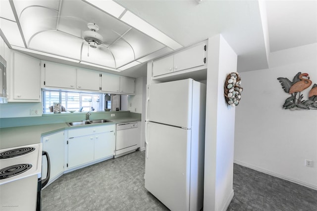 kitchen with light floors, white appliances, light countertops, and a sink
