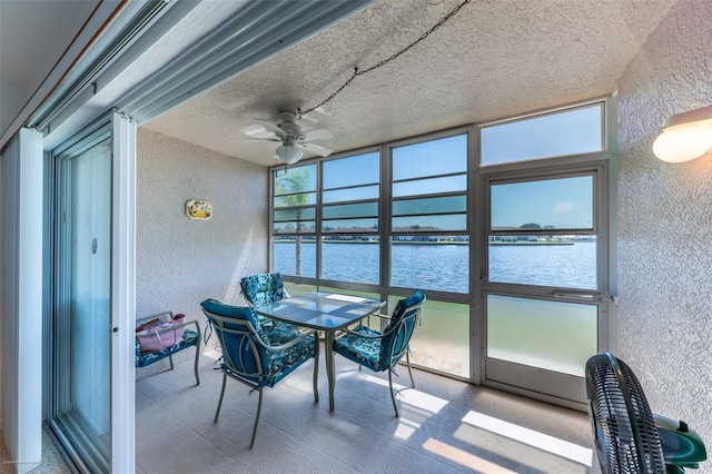sunroom / solarium featuring a water view