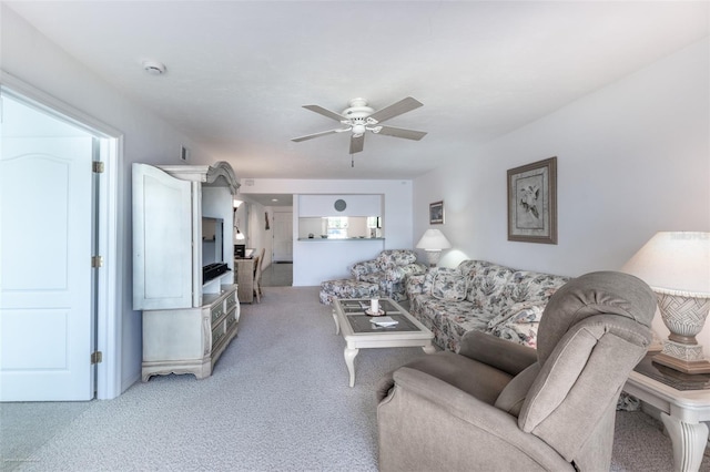 living room with light colored carpet and a ceiling fan