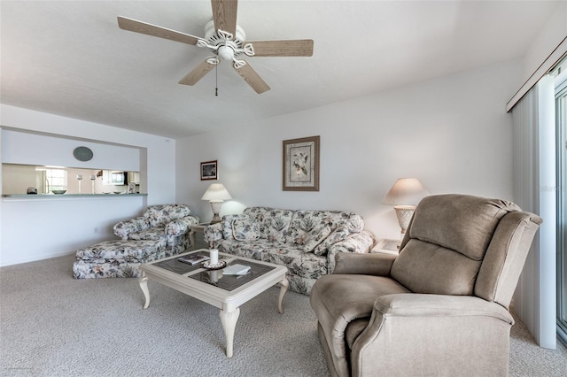 living room featuring carpet floors and a ceiling fan
