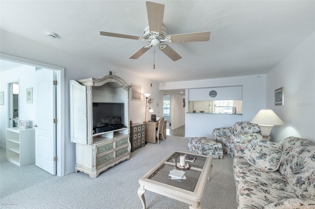 living area featuring carpet flooring and ceiling fan