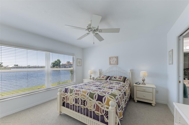 carpeted bedroom with ceiling fan and baseboards