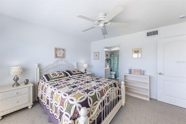 carpeted bedroom with connected bathroom, visible vents, baseboards, and a ceiling fan